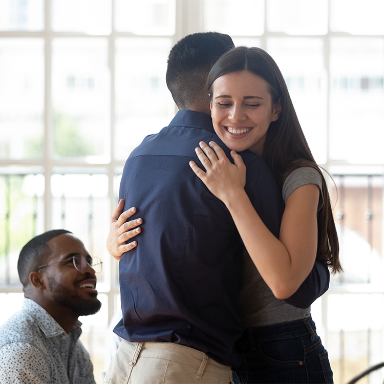 Relieved happy man and woman embrace give support during therapy